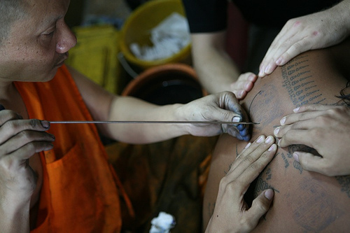 Tribal tattoo desig with needle .